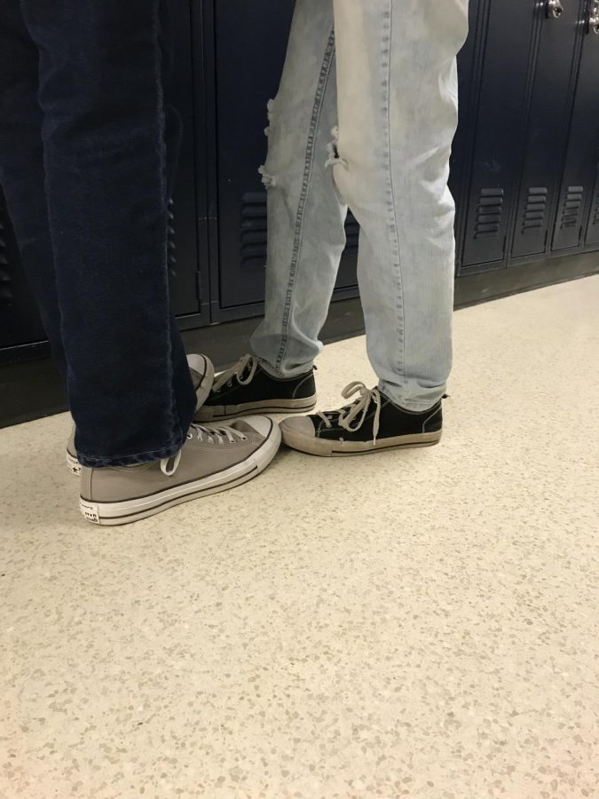 Students stand close together by the lockers before class. PDA is an issue at the high school. 