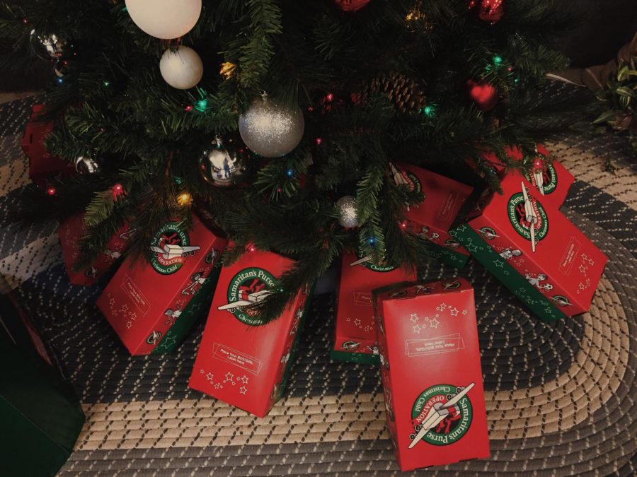 The Newville First Church of Gods packages sit under a Christmas tree. These are the official boxes of Operation Christmas Child, but other types of boxes are welcomed. 