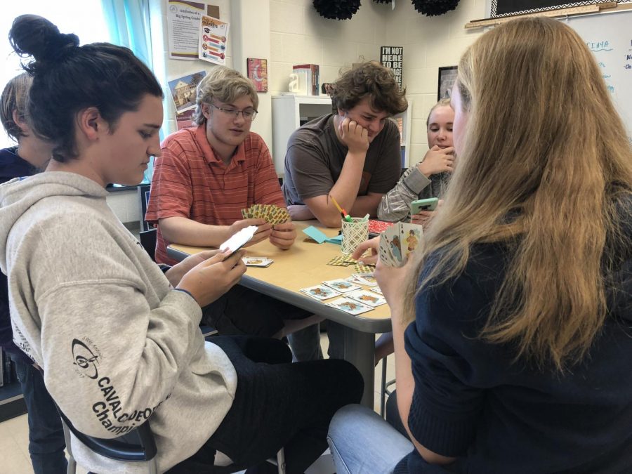  A friend group of sophomores gather to play war during their free period. Playing cards during their free period is a was for students to calm down and enjoy the simple things in life.