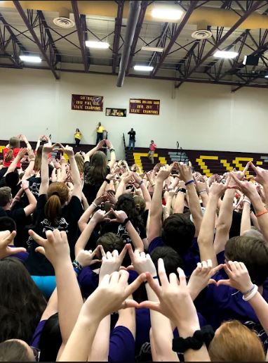 Students of Mini-Thon holding peace. Mini-Thon was a blast