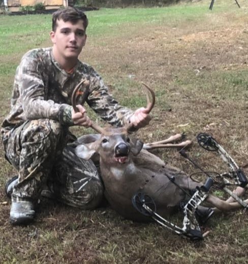 Logan posing with his kill. He shot a buck. 