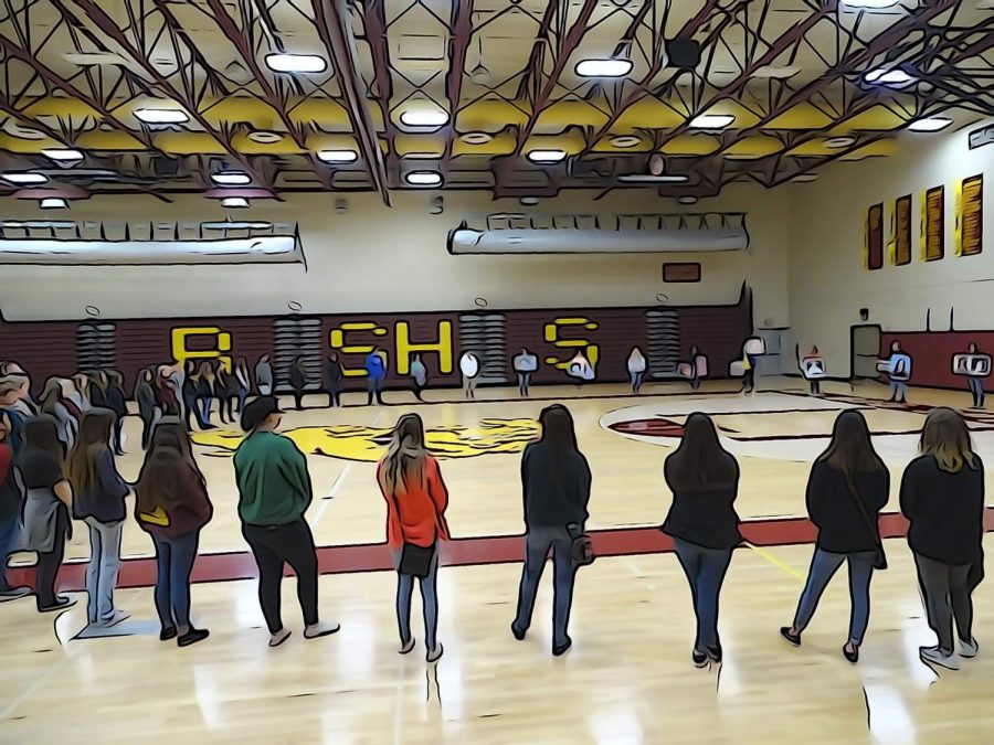 Students stand in a circle on the March 14th Walkout. The walkout was held to memorialize the lives lost in Parkland. 