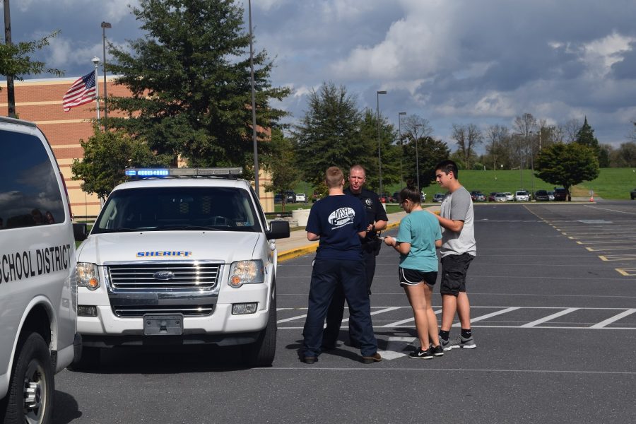 Deputy+Brian+Gryzboski+demonstrates+how+an+officer+would+approach+a+vehicle+in+the+event+of+a+traffic+stop.+Students+in+each+Drivers+Ed+class+for+the+past+2+years+have+had+the+opportunity+to+participate+in+a+mock+traffic+stop+lesson.