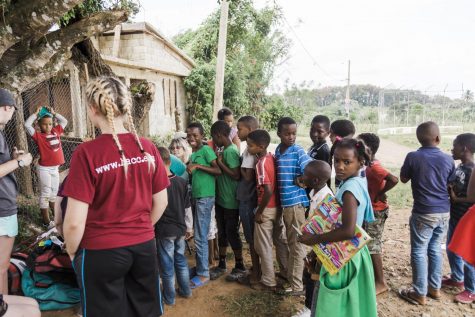 Kids from the Dominican gather around the missionary leaders. Jones was one of the missionaries there to provide guidance and the gospel. 