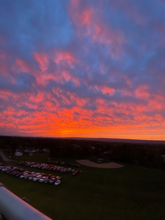 The sun sets after a Friday night football game