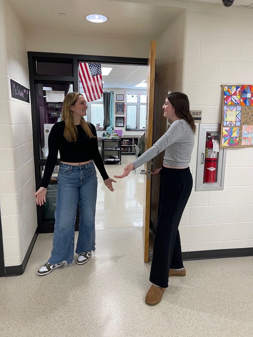 Students practice good social skills, while holding the door open for one another. 