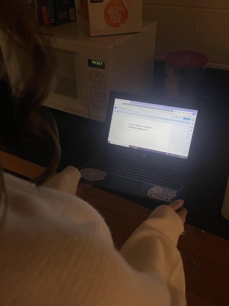 Student is pictured using AI to write her assignment.